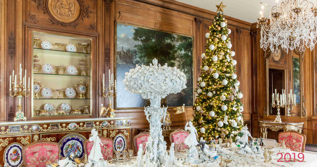 2019 decorated holiday tree in mansion dining room with porcelain ceramics on tabletop