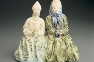TWO SEATED WOMEN IN PEASANT COSTUME