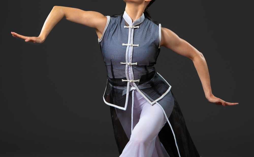 Image of dancer posing with arms extended.